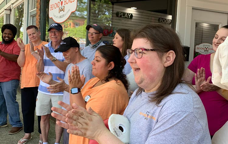 Members of Arc of Allegan stand outside Beyond Bones enjoying a parade.