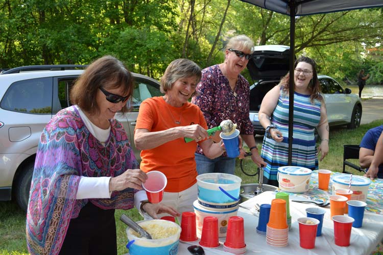 Volunteers help out at an Arc of Allegan picnic by making root beer floats.