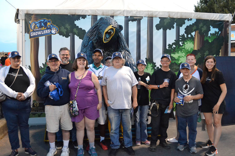 Arc of Allegan members and volunteers pose together while they attend a Kalamazoo Growlers game.