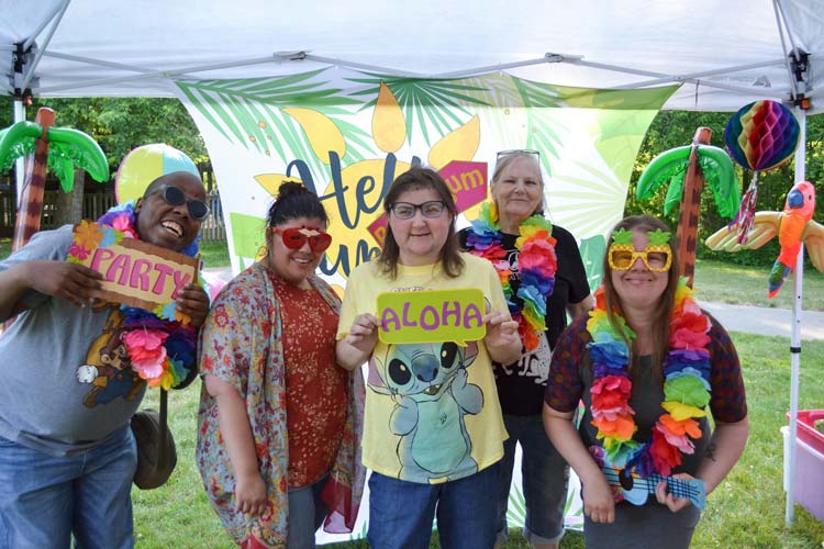 arc of allegan county members dressed in bright colors and Hawaiian shirts participating in an aloha festival