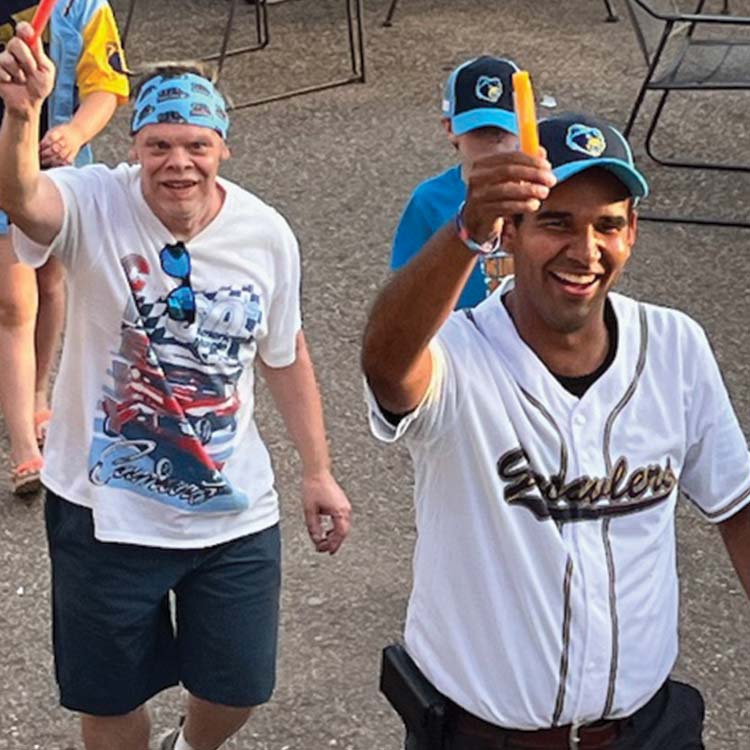 members of arc of allegan attending a growlers baseball game enjoying popiscles