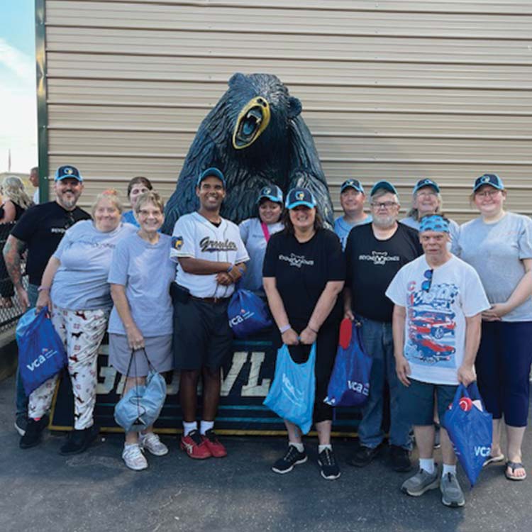 group photo of arc members with the growlers mascot statue 